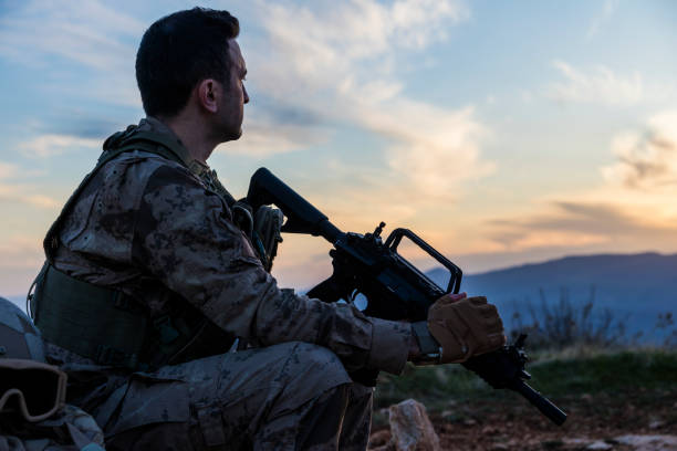 istock Army Soldier in the battlefield at sunset 1313007964