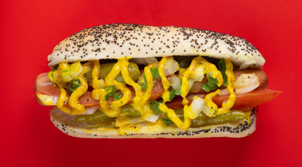 Chicago Style Hot Dog Photograph of a classic Chicago Style hot dog, ready to enjoy. Dragged through the garden. With 2 sport peppers, pickle spear, celery salt, neon green relish, tomato, white onion, mustard and of course no ketchup. hot dog photos stock pictures, royalty-free photos & images