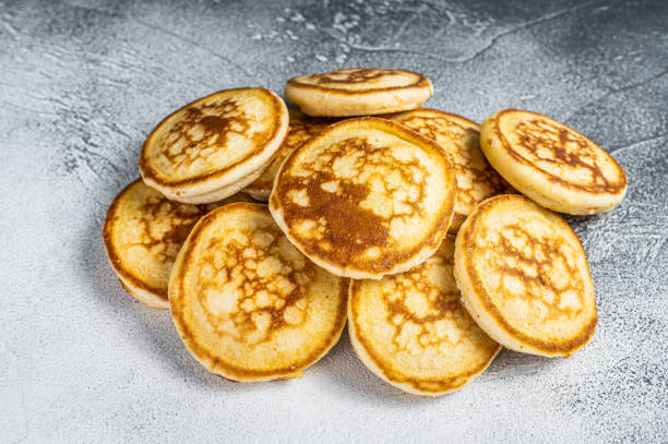 istock Stack of buttered pancakes on a kitchen table. White background. Top View 1313011480