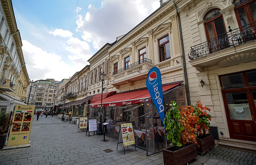 Bucharest, Romania - April 08, 2021: Old-style streets with houses with a beautiful architecture where bars, pubs, coffee shops, restaurants, terraces are opened in the old city of Bucharest