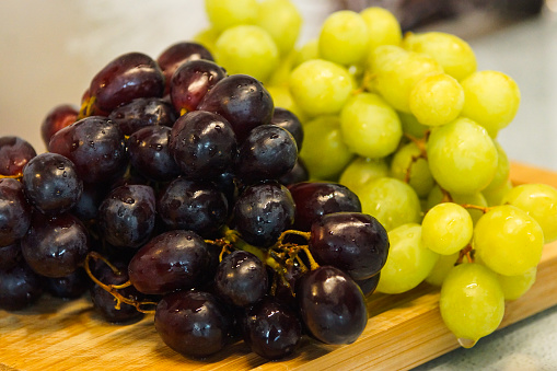 Wet grapes, red/white grapes, fresh grapes, blurry background