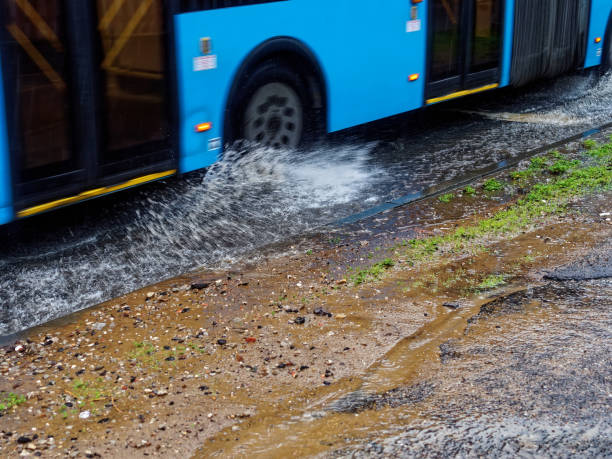 istock strong splashes from under the wheels of the bus 1313013832