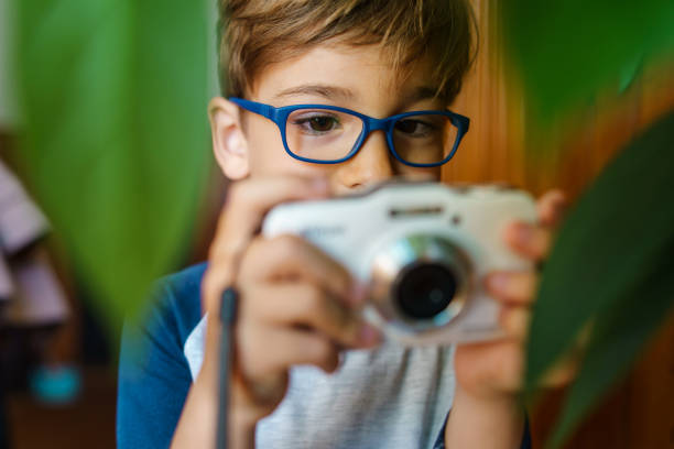Young artist with retro camera during a shooting process