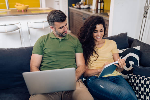 istock Man working online while his wife reading a book 1313018330