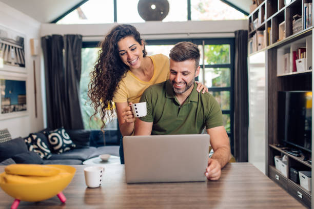 istock Happy couple working together from home 1313018337