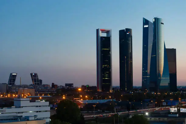 Photo of Madrid, Spain- April 3, 2021: Skyline of Madrid at sunset.  Towers of Madrid.  Skyscrapers at sunset