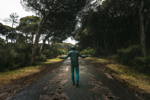 istock Wet man walking in nature during heavy rain. Bad rainy autumn wether. 1313025597