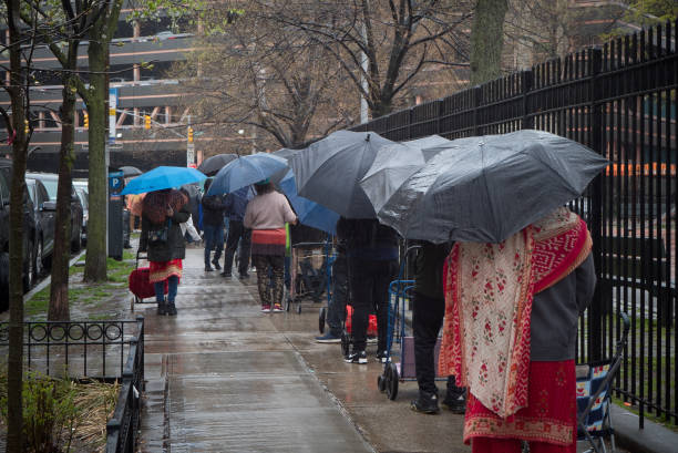 Queens, New York. April 15, 2021. People waiting in line for food distribution charity in Elmhurst.