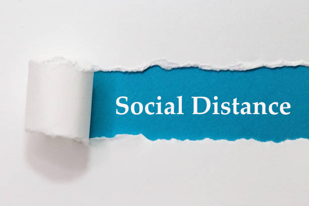 istock Social Distance Written Torn Paper 1313030532