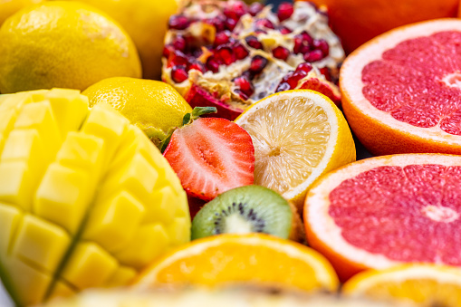 Close up of arranged halved fruits. Cross section of various citruses. Raw food and healthy lifestyle concept.