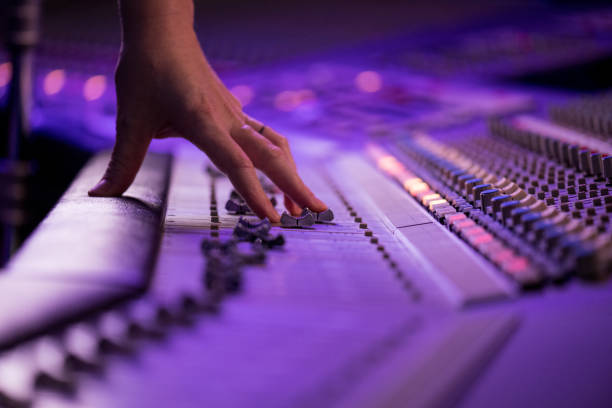 istock Hand operating with faders on sound mixing control panel in recording studio. 1313030737