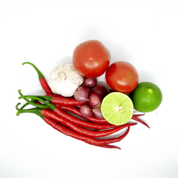 istock kitchen ingredients consisting of fresh red chilies, tomatoes and onions on a white background 1313041995