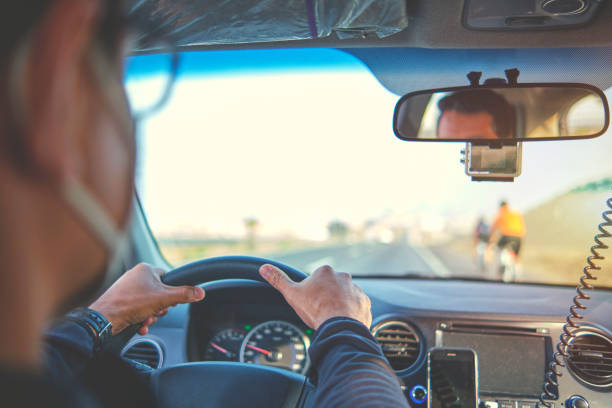 istock Group of professional cyclists training on highway with safety escort car, security light 1313045331
