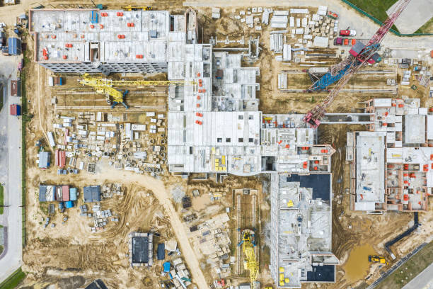 istock new building under construction with working cranes. aerial drone top down view. 1313052814
