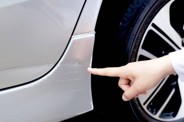 istock Scratched car paint with door handle and tire 1313056985