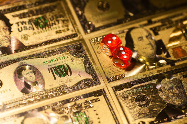 istock Casino red dices on gaming table US Dollar bills background 1313058713