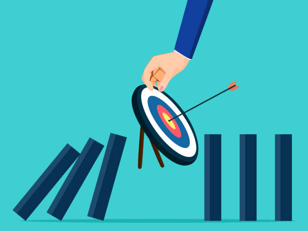 istock The businessman protects the domino from falling by placing a goal vector 1313059288