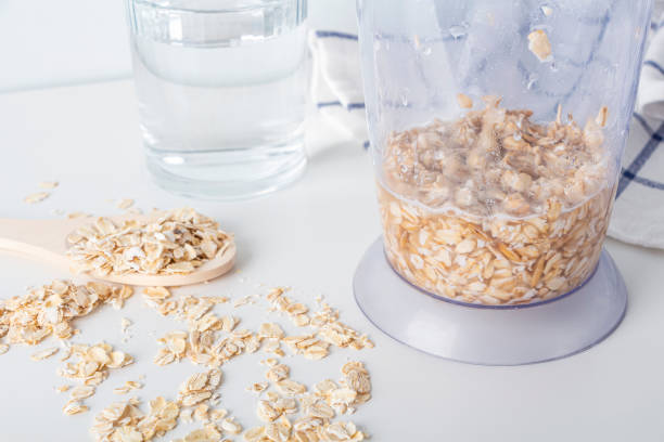 Step by step recipe. Cooking oat vegetable milk. Step 2 pour oatmeal with water in blender. Homemade food concept. Plant based organic veggie milk, lactose free