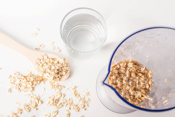 istock Step by step recipe. Cooking oat vegetable milk. Step 2 pour oatmeal with water in blender. Homemade food concept. Plant based organic veggie milk, lactose free 1313060401
