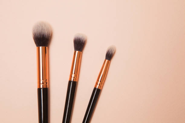 istock Various cosmetic brushes on pink background. Makeup brushes set for take care skin. 1313061060