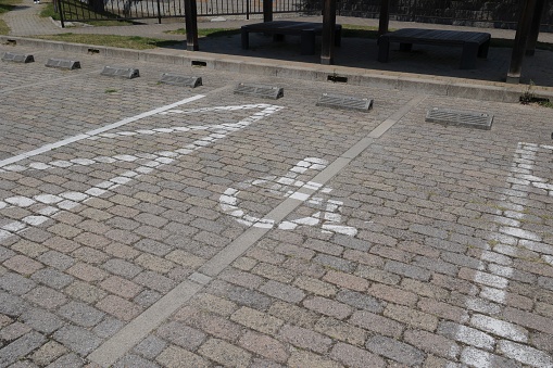 A wheelchair mark is drawn on the parking lot.