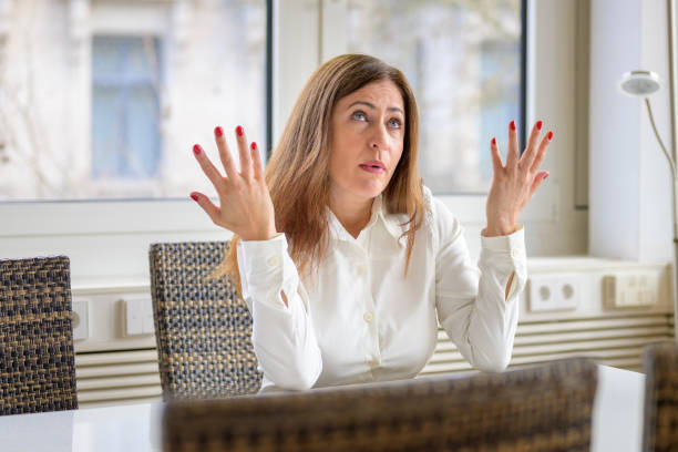 istock Woman shrugging her shoulders and gesturing with her hands 1313061240