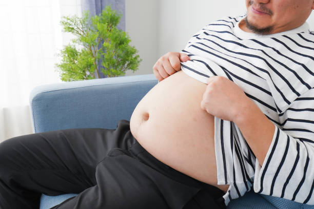 istock An obese man who eats too much 1313062982