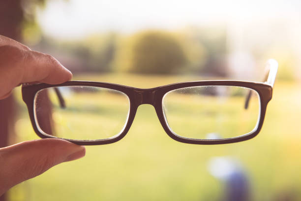 istock Sense concept: holding black glasses outdoors 1313067853