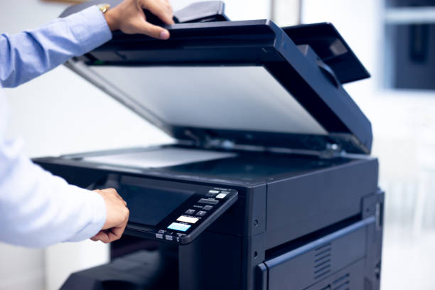 istock Bussiness man Hand press button on panel of printer, printer scanner laser in office copy machine supplies start concept. 1313069737