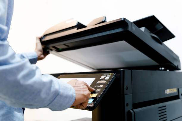 istock Bussiness man Hand press button on panel of printer, printer scanner laser in office copy machine supplies start concept. 1313069765