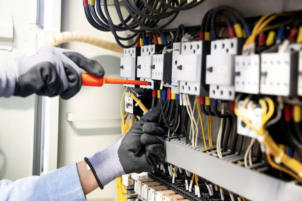 istock Electricians work to connect electric wires in the system, switchboard, electrical system in Control cabinet. 1313069827