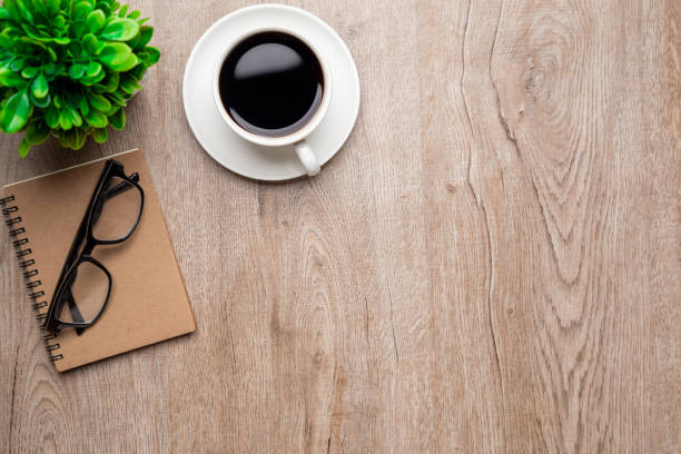 istock Flat lay, top view office table desk. Workspace with, laptop,office supplies, pencil, green leaf, and coffee cup on wood background. 1313069880