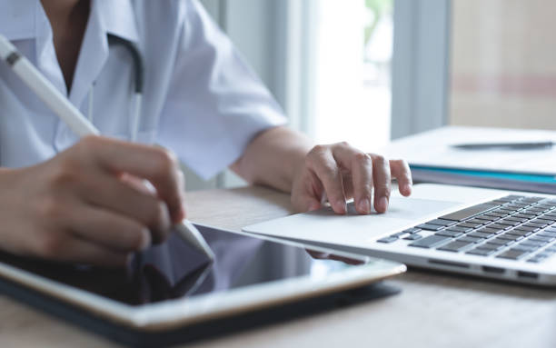 istock Doctor working on digital tablet and laptop computer in office 1313070528