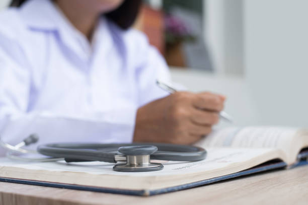 istock Doctor reading anatomy textbook 1313070576