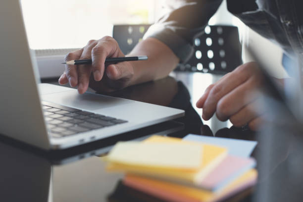 istock Man working on laptop computer searching information and planning startup project in office 1313070627