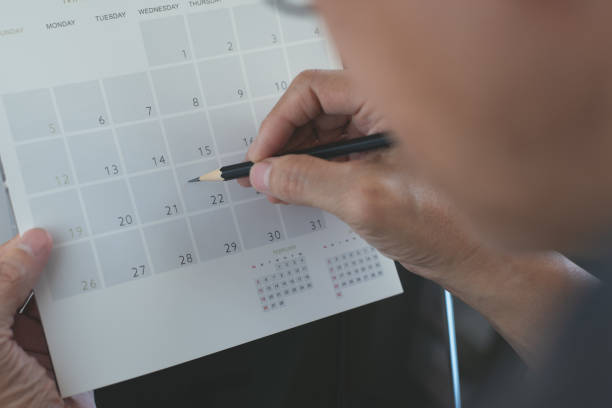 istock Business man planning his work schedule on calendar  event planner, timetable in office 1313070632