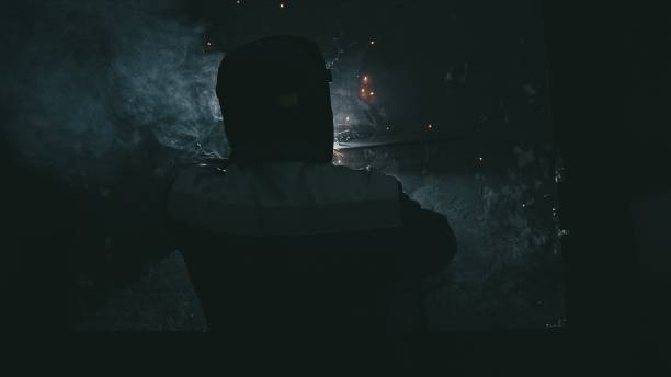 istock Forge workshop. Smithy. Worker in a welding hood helmet welds a part by electric welding. Sparks are reflected in the protective screen. 1313071816