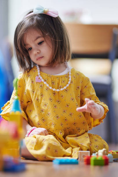 istock Little girl play with blocks 1313072847
