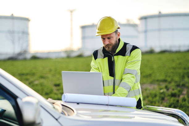 istock Engenner using laptop while working in front of oil rafinery. 1313074353