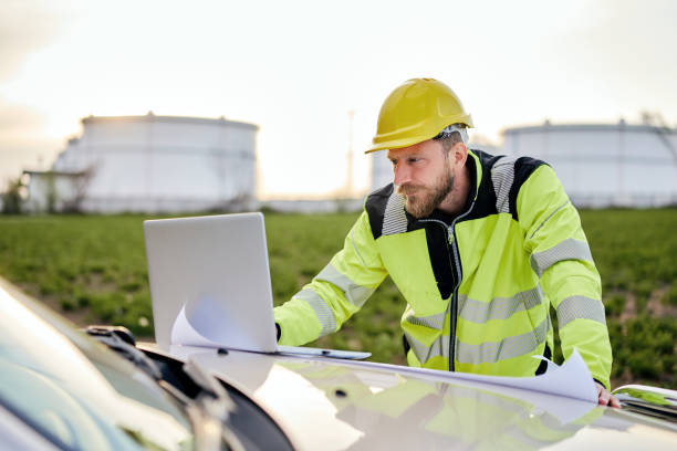 istock Engenner using laptop while working in front of oil rafinery. 1313074359