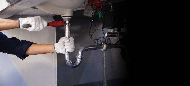 istock Plumber fixing white sink pipe with adjustable wrench. 1313078518