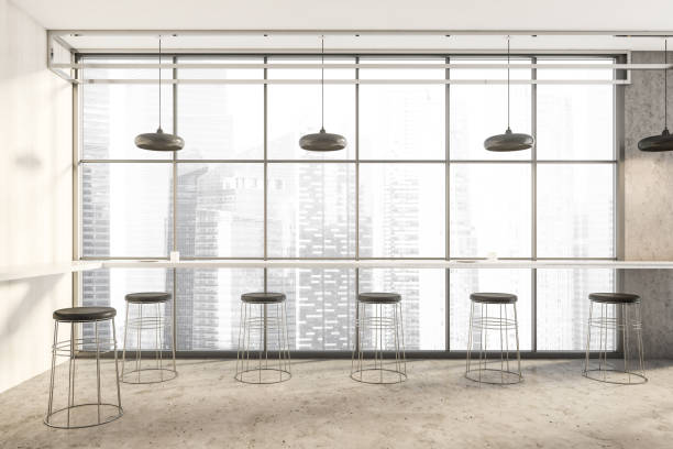 istock Light cafe interior with many seats and long table along wall and window 1313079505