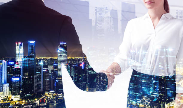 istock Business people handshake, skyscrapers at night 1313081060