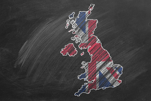 Country map and flag of United Kingdom drawing with chalk on a blackboard. Hand drawn animation. One of a large series of maps and flags of different countries. Education, travel, study abroad concept
