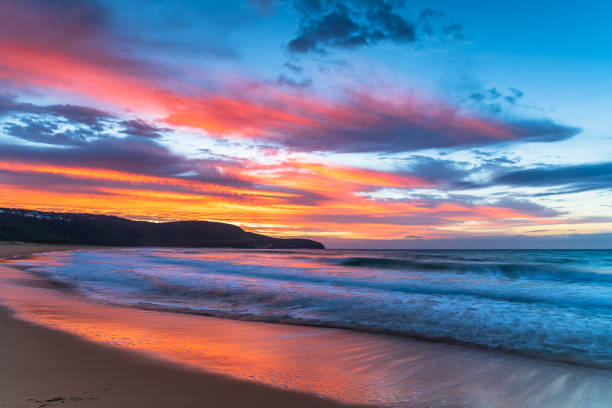 istock Sunrise at the seaside with pastel coloured clouds 1313082074