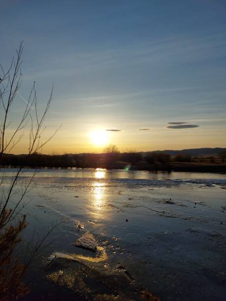 istock Melting River Ice and Water in Spring Sunset with Mountain on Horizon 1313084486