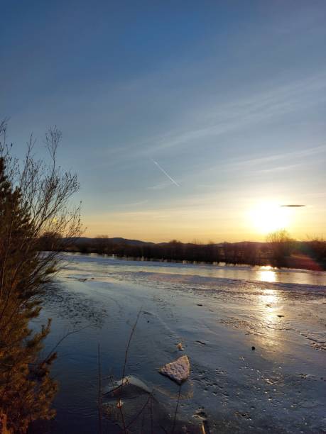istock Melting River Ice and Water in Spring Sunset with Mountain on Horizon 1313084507