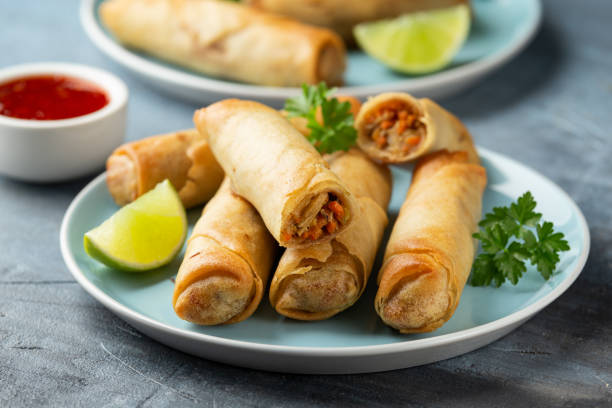 istock Fried spring rolls with sweet chili sauce and lime on plate 1313085971
