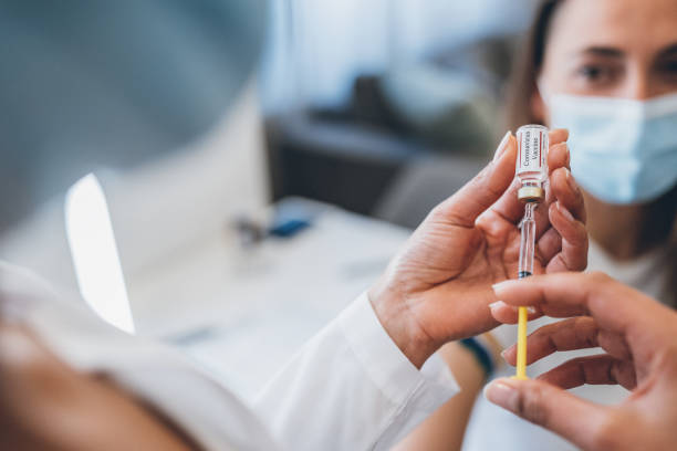 istock Preparing injection with covid-19 vaccine 1313089228