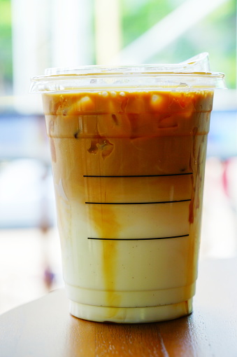 Close-up latte in disposable take away cup Iced